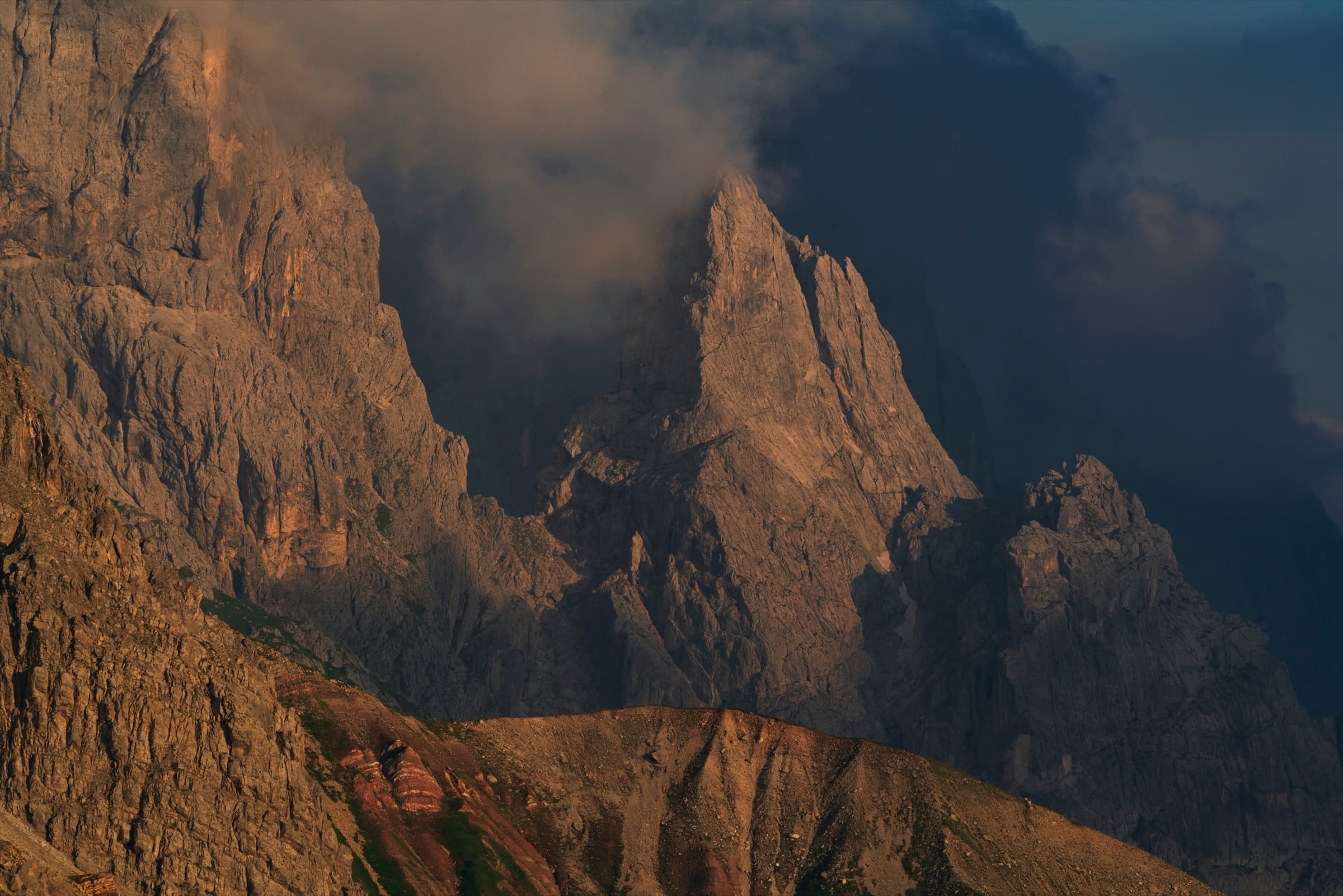 Distant ridges catching the last warm light beneath a darkening sky
